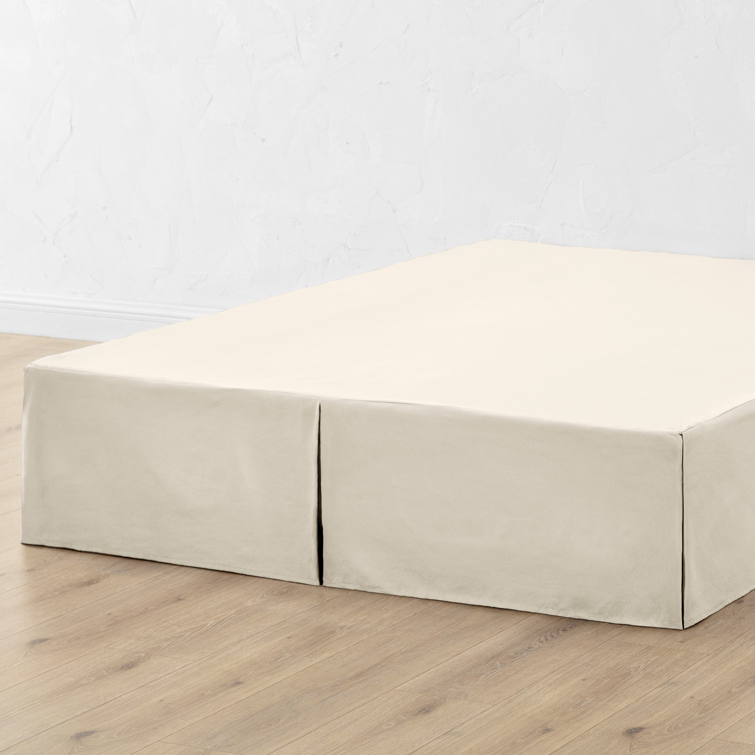 A bed skirt draped over a box spring