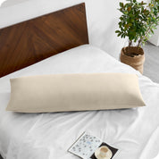 A body pillowcase on a pillow on a bed with all white bedding