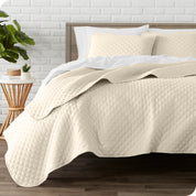 A quilted coverlet set on a bed