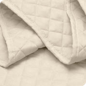 Close up of a coverlet showing the stitching