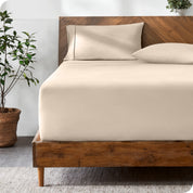 A modern bed with a fitted microfiber sheet made on the mattress. 