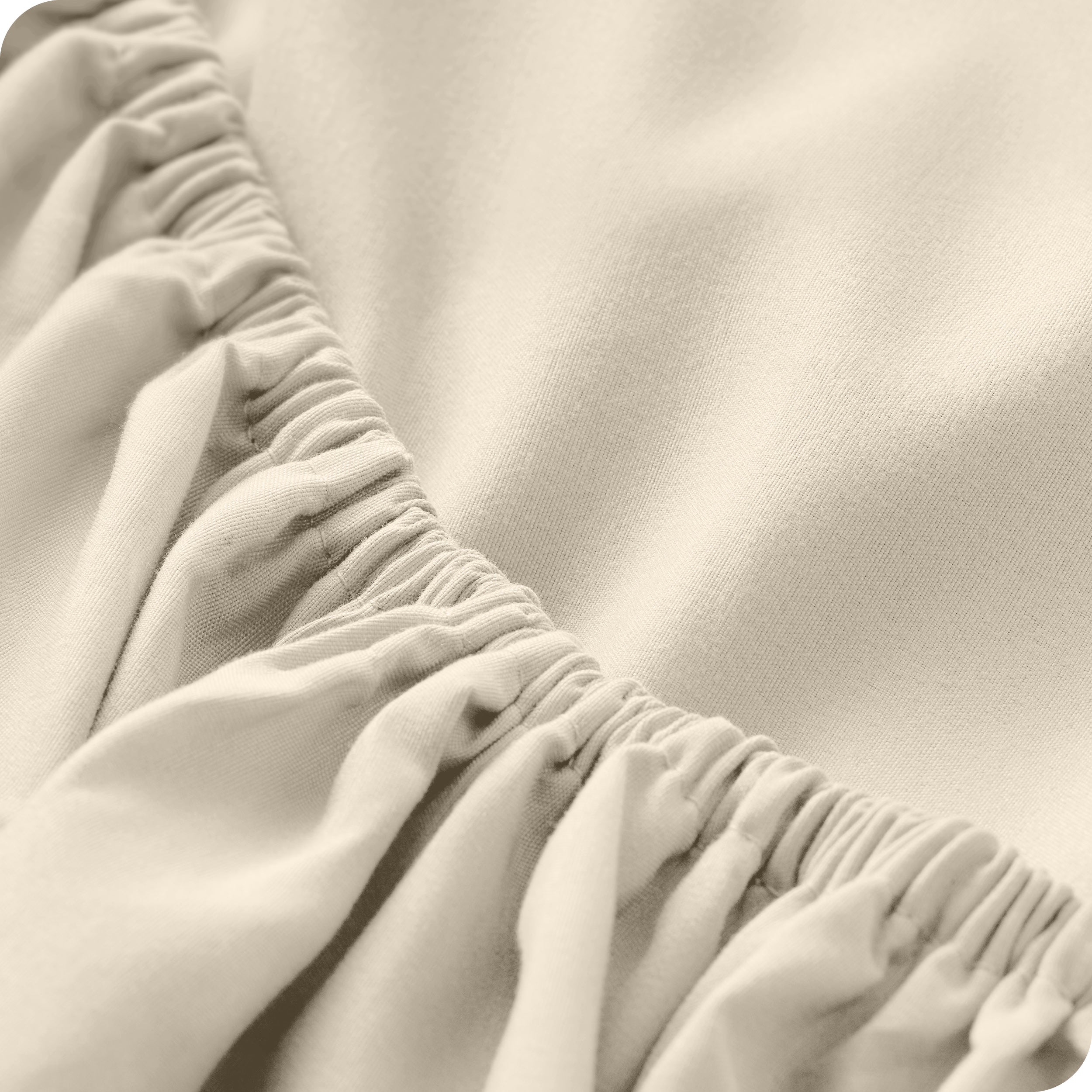 A close up of the elastic of a microfiber fitted sheet. 