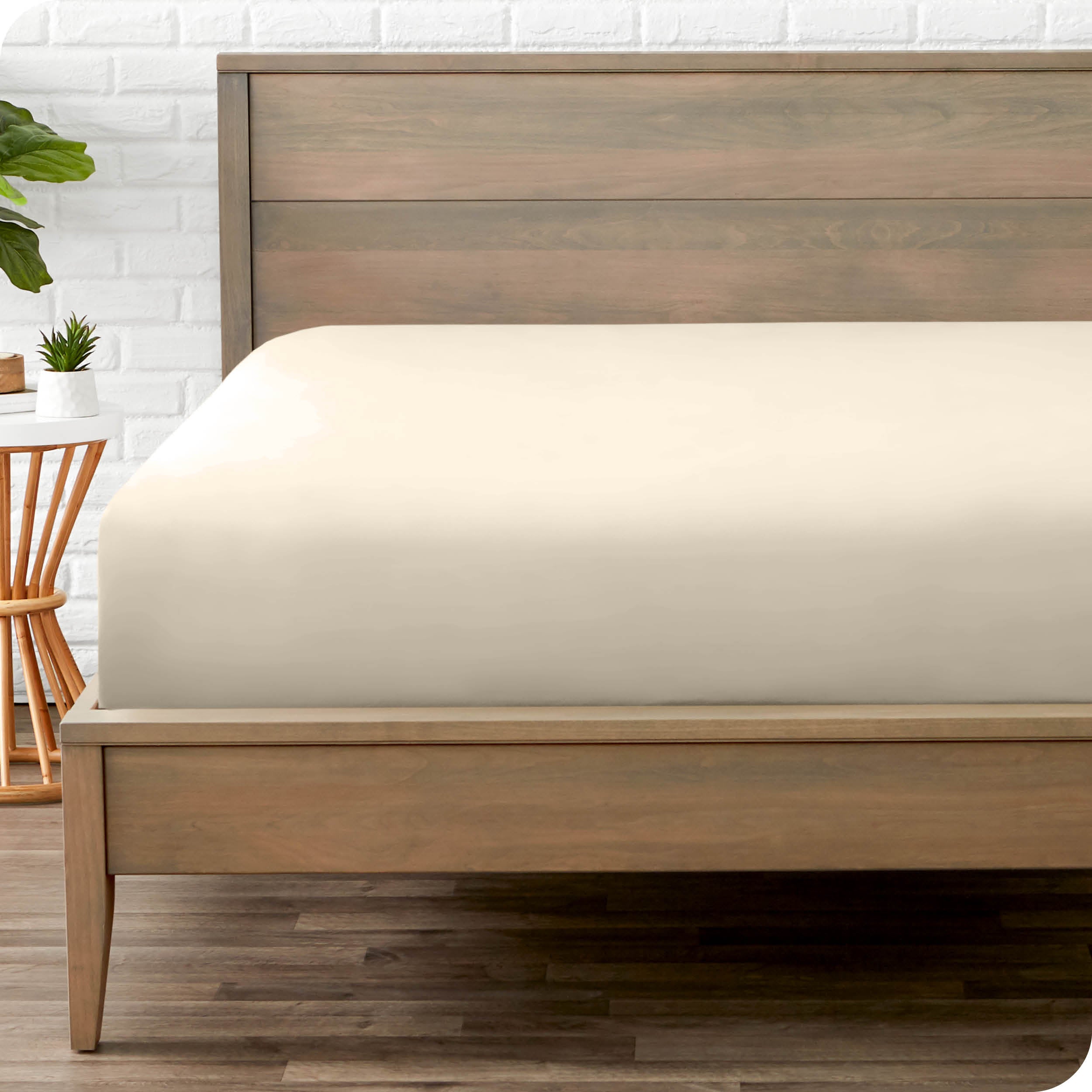 End of bed view with fitted sheet made on the mattress of a modern bed. 