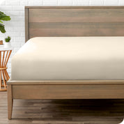 End of bed view with fitted sheet made on the mattress of a modern bed. 