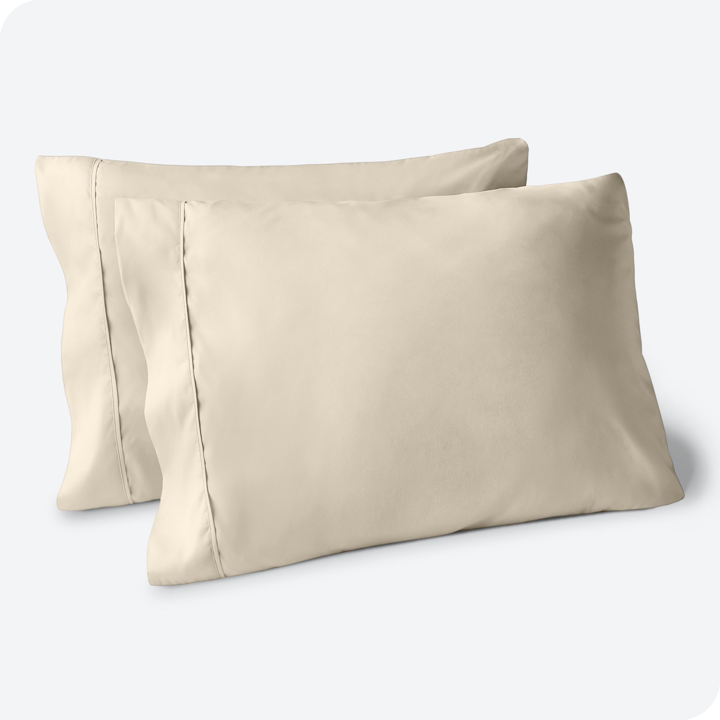 Two pillows on a white background with blue pillowcases on them