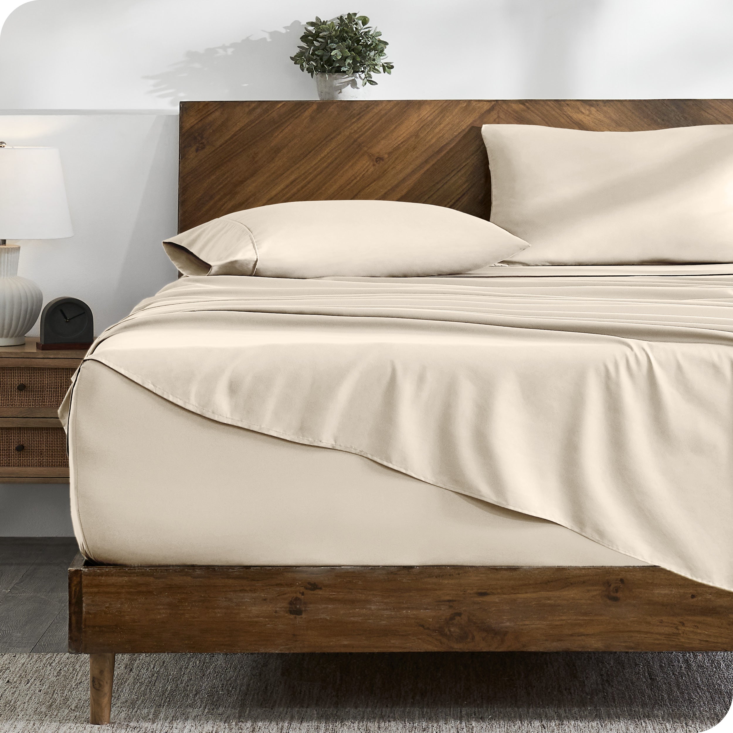 A cozy bedroom with a bed covered in soft microfiber sheets

