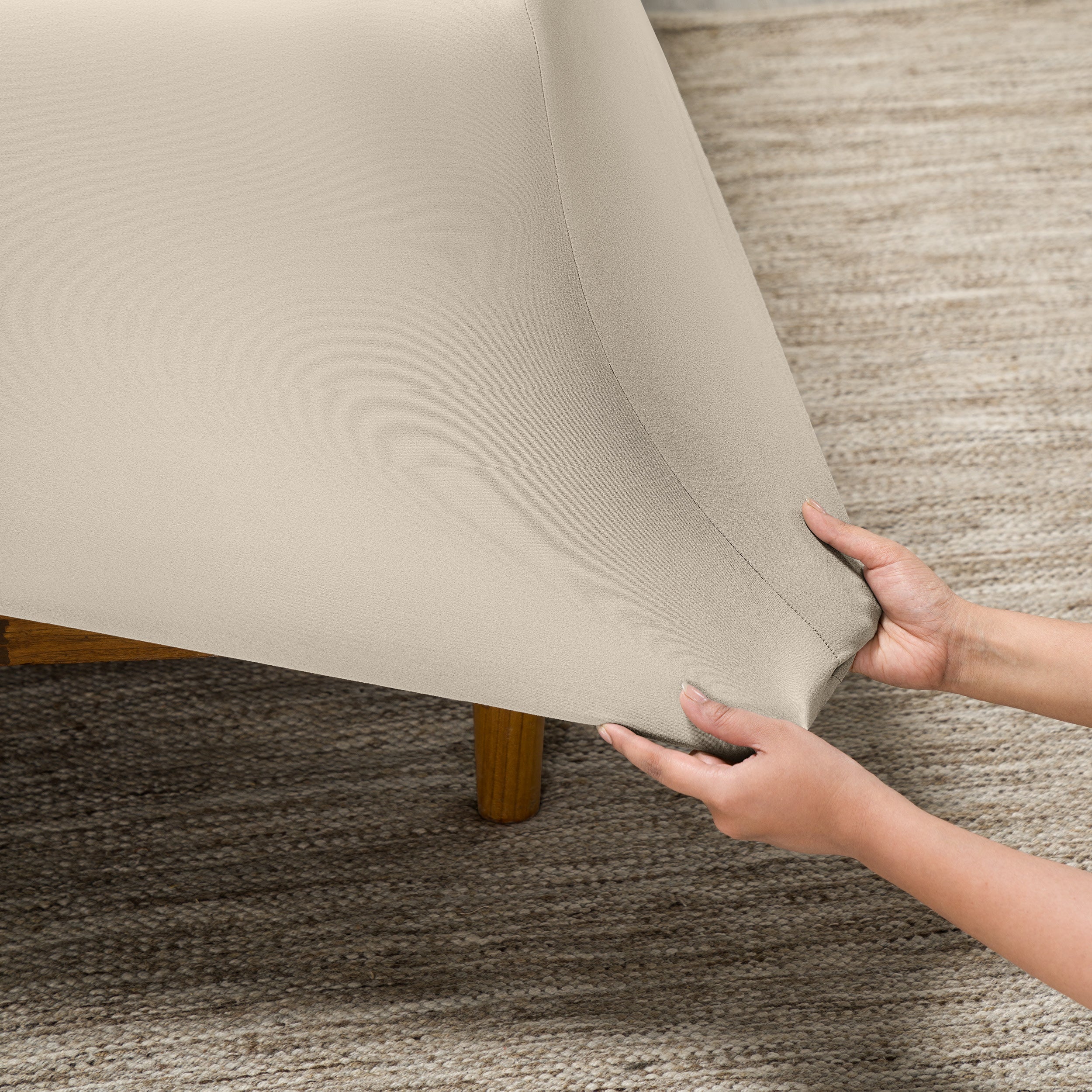 Person putting a stretch fitted sheet on a mattress