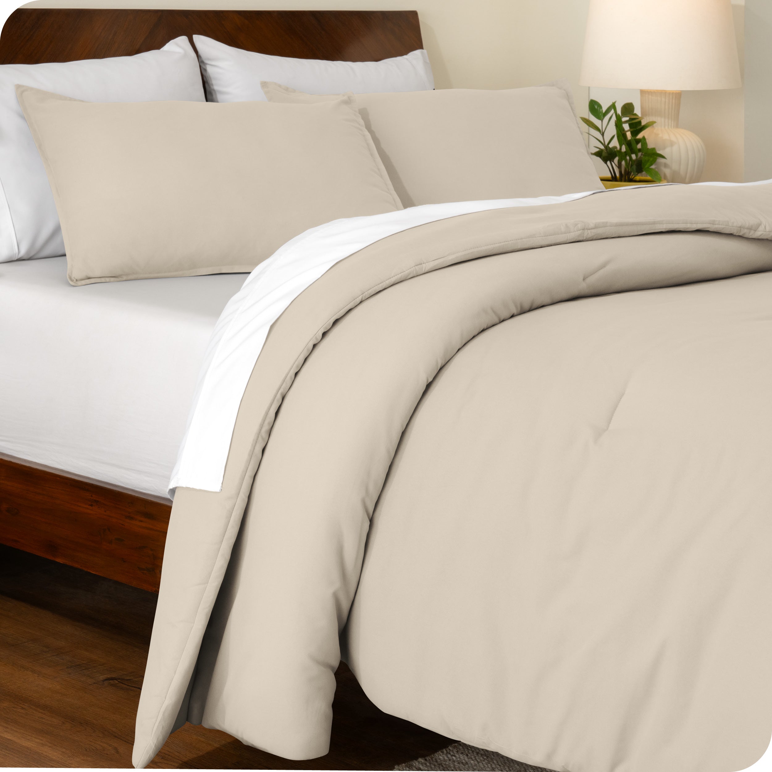 A side view of a bed made with a track stitch comforter set