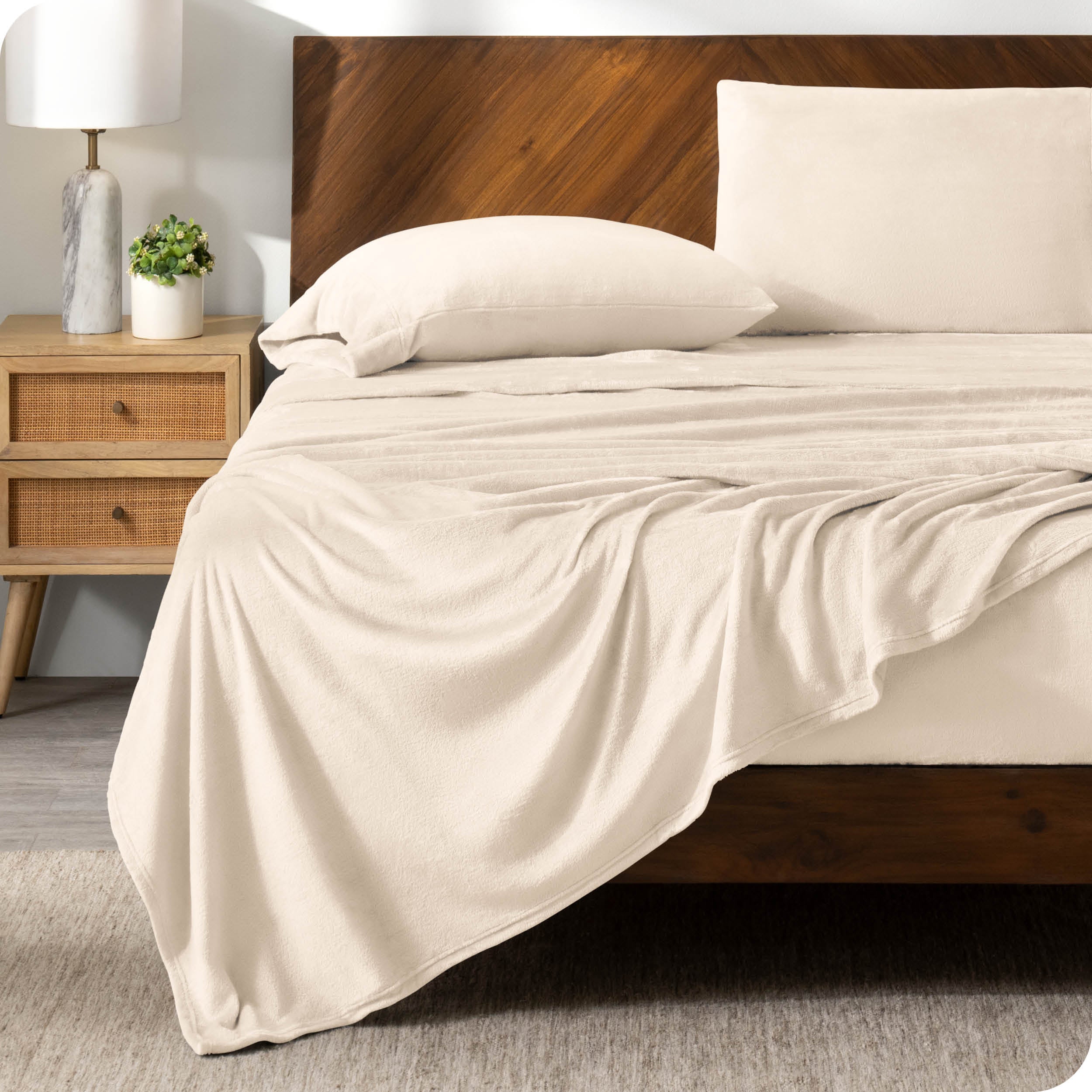 A sand sheet set on a bed with a wooden bed frame