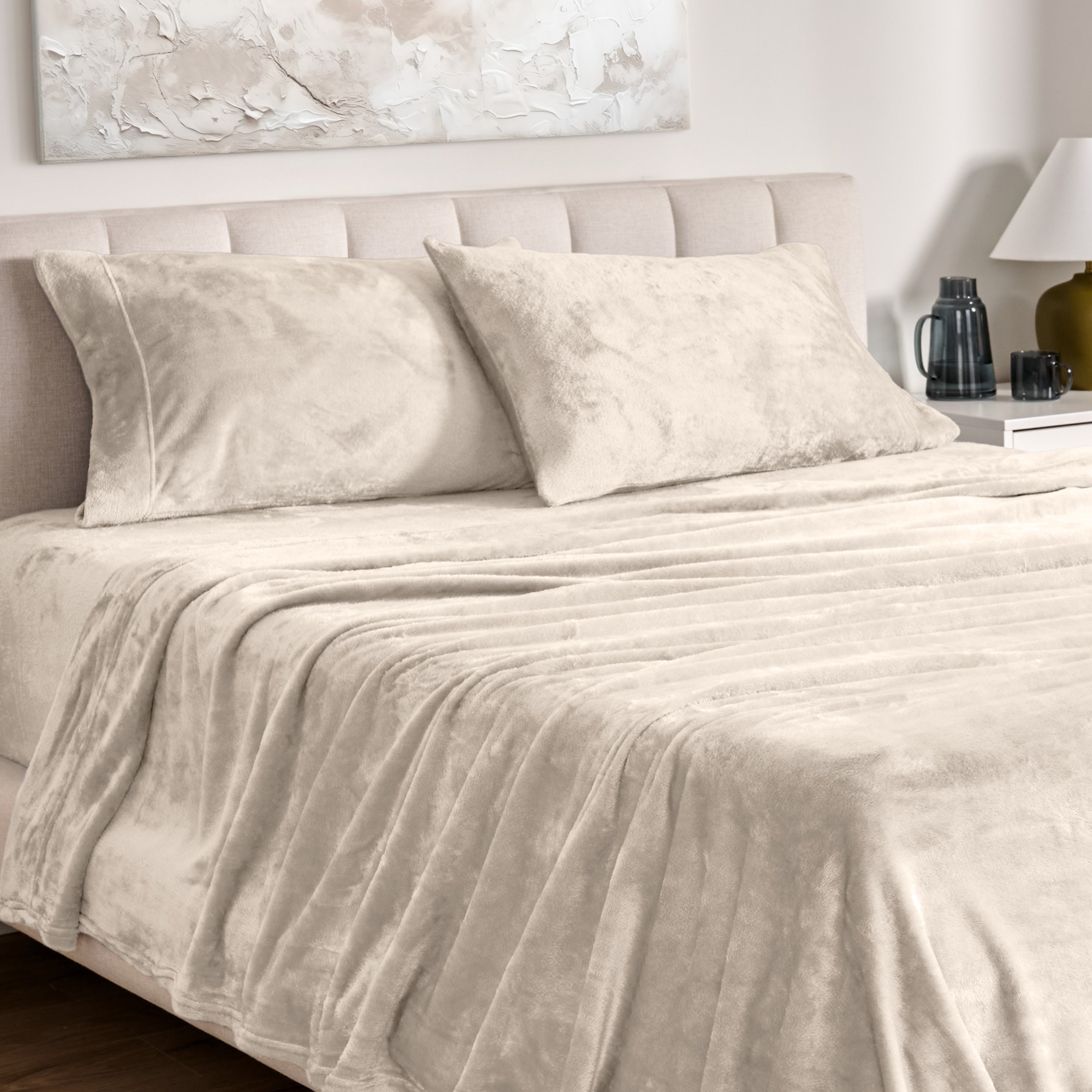 Microplush bed sheets and pillowcases on a bed with a neutral headboard and decor.