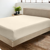 A sateen fitted sheet on a bed