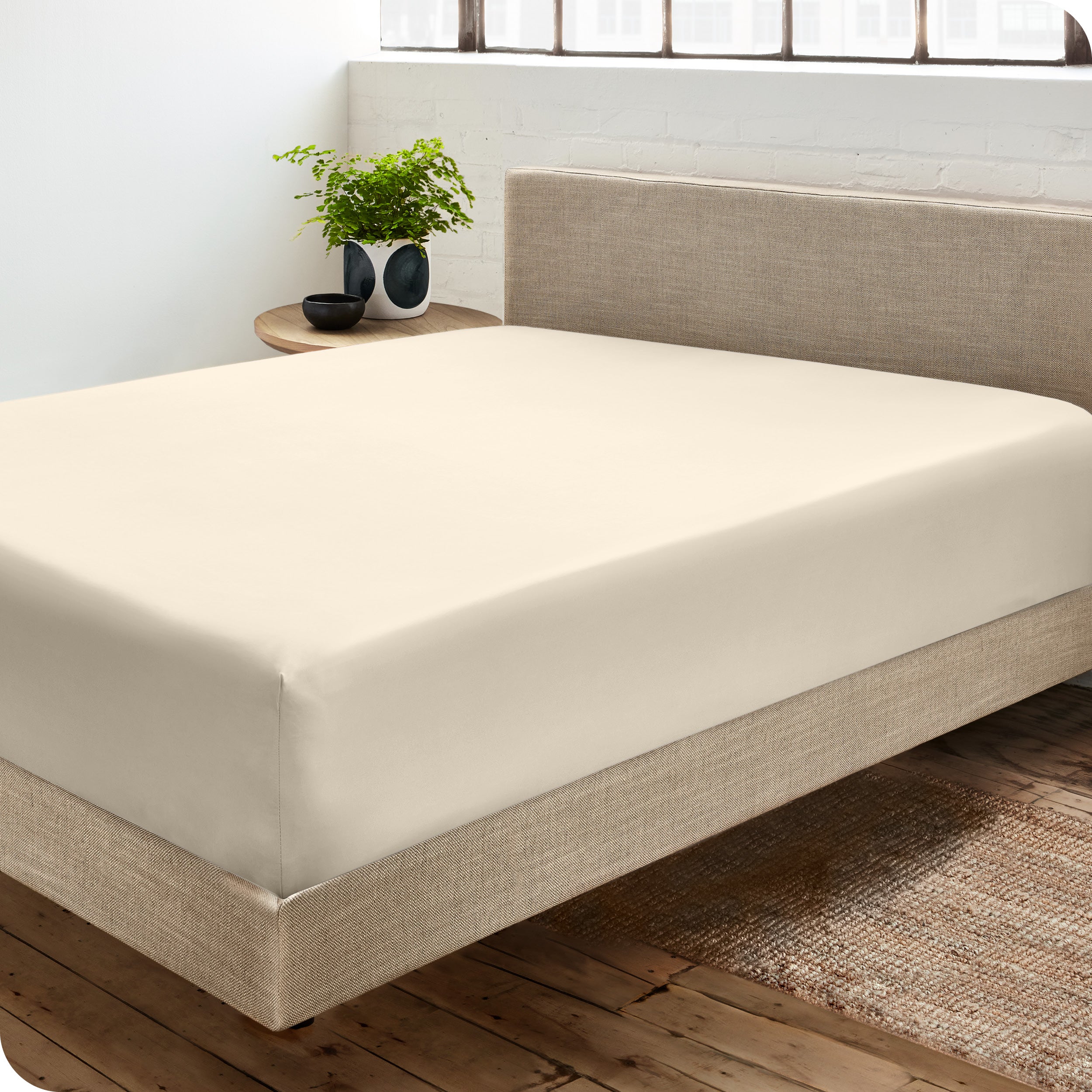 A sateen fitted sheet on a bed