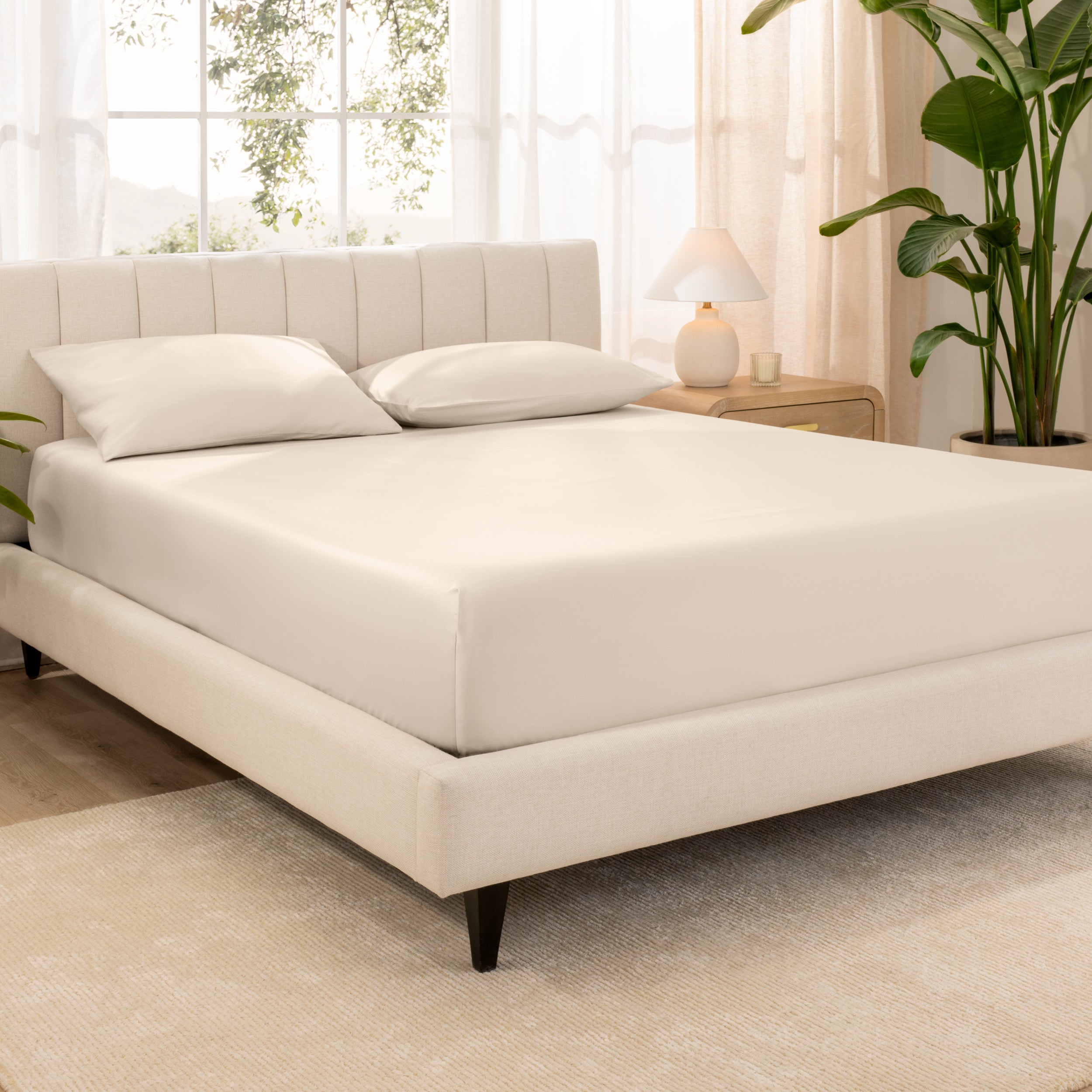 A sateen fitted sheet over a bed
