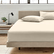 An organic cotton fitted sheet on a mattress