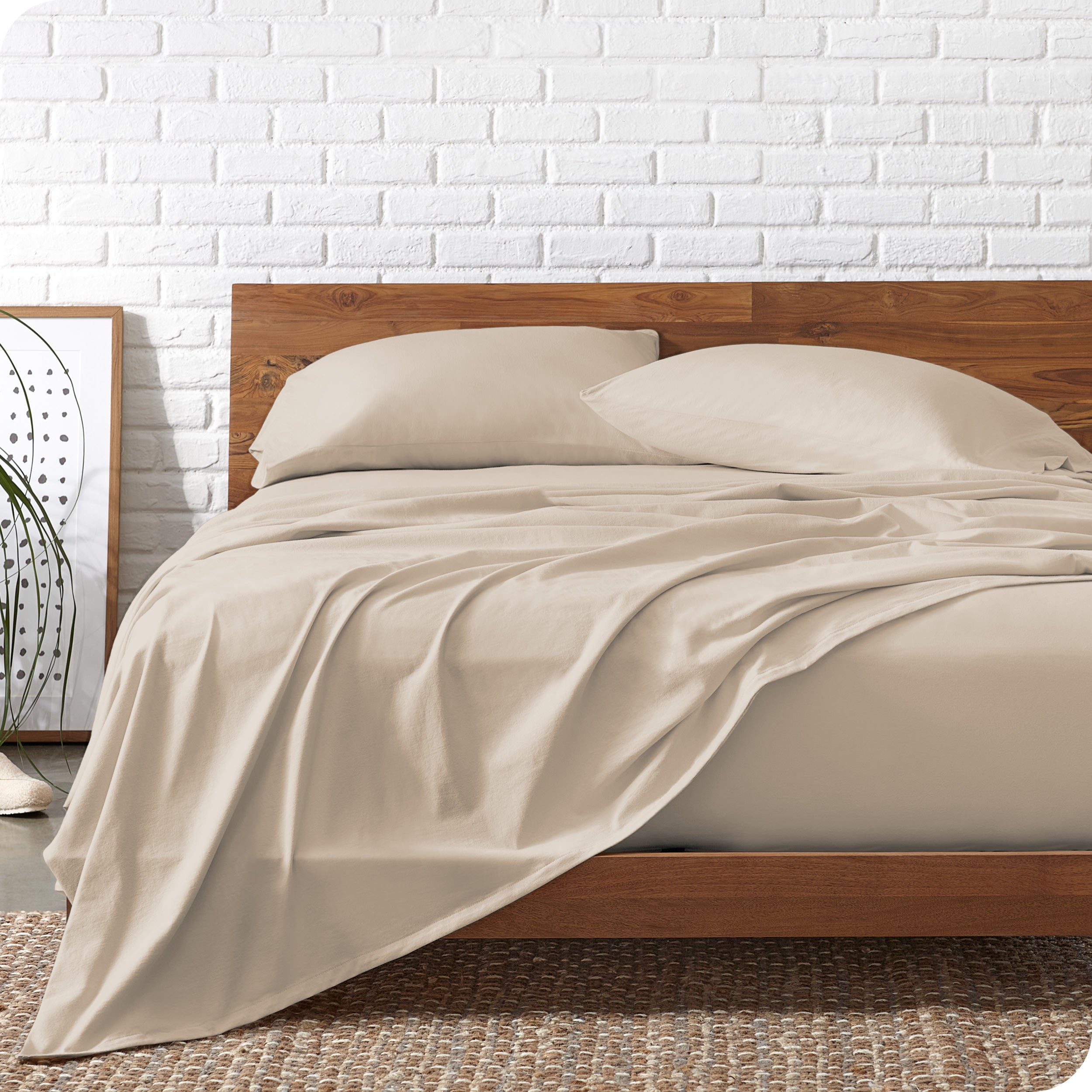 Organic jersey sheets on a bed with a wooden bed frame
