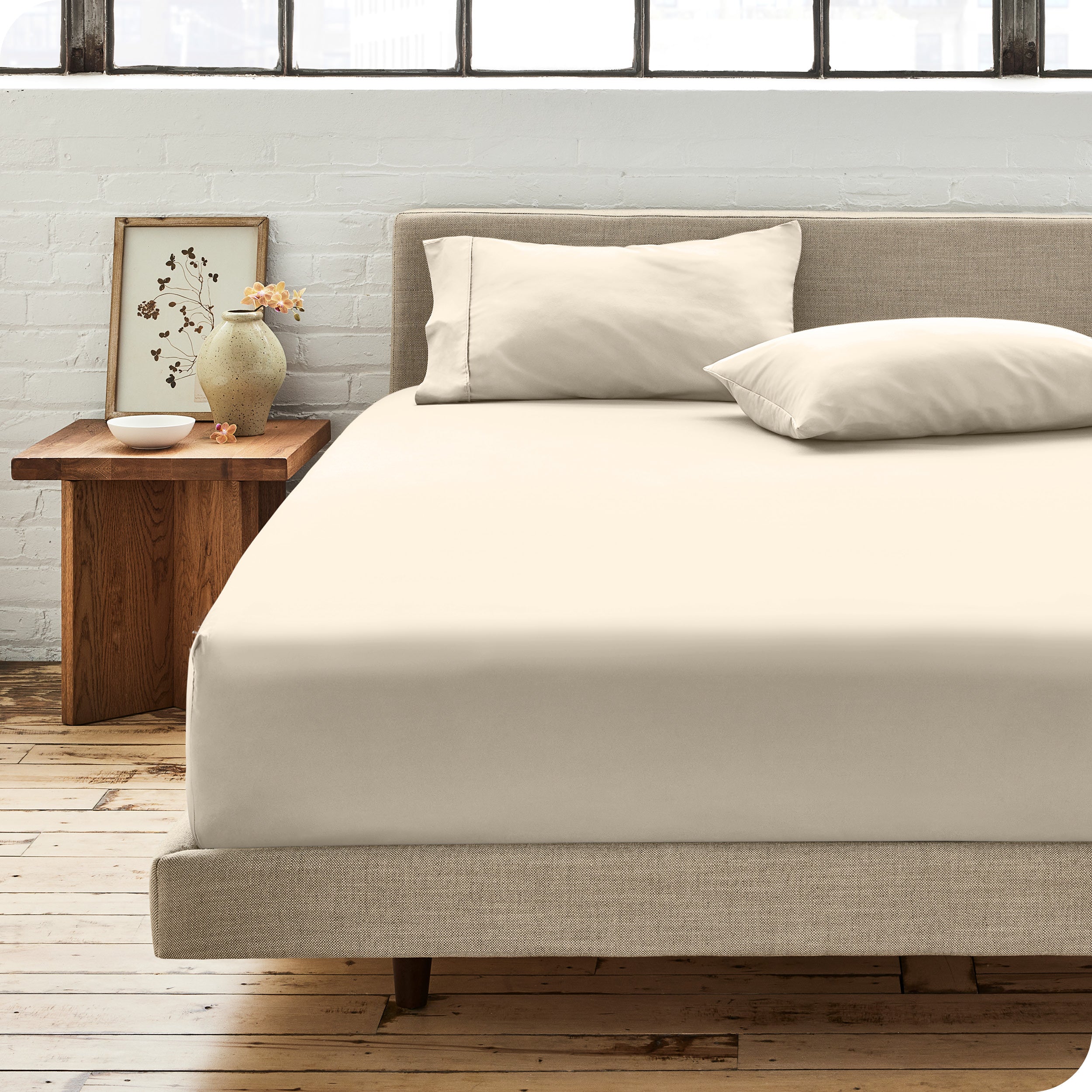 Percale fitted sheet on a mattress with matching pillowcases on pillows
