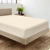 A single organic cotton fitted sheet on a bed