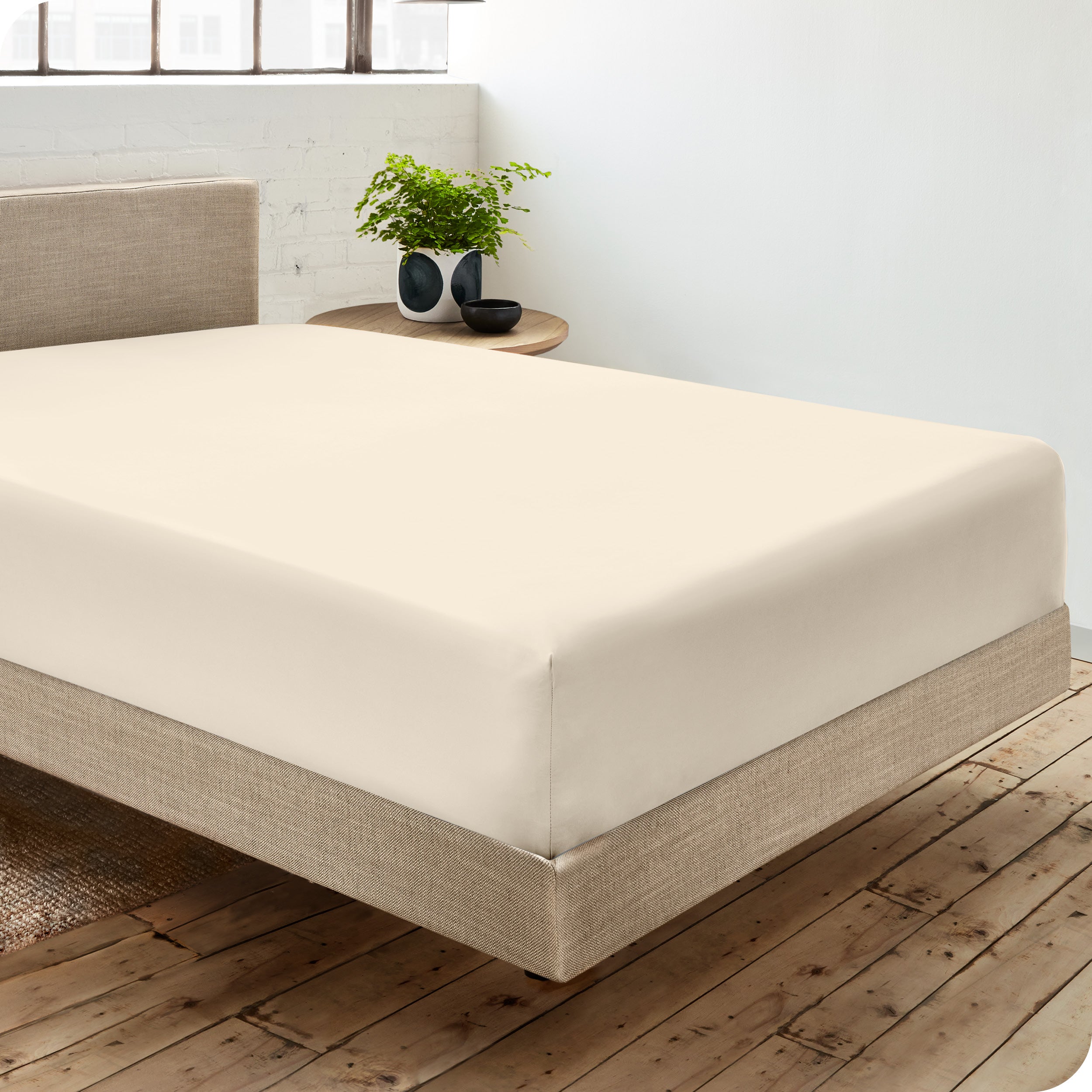 A single organic cotton fitted sheet on a bed