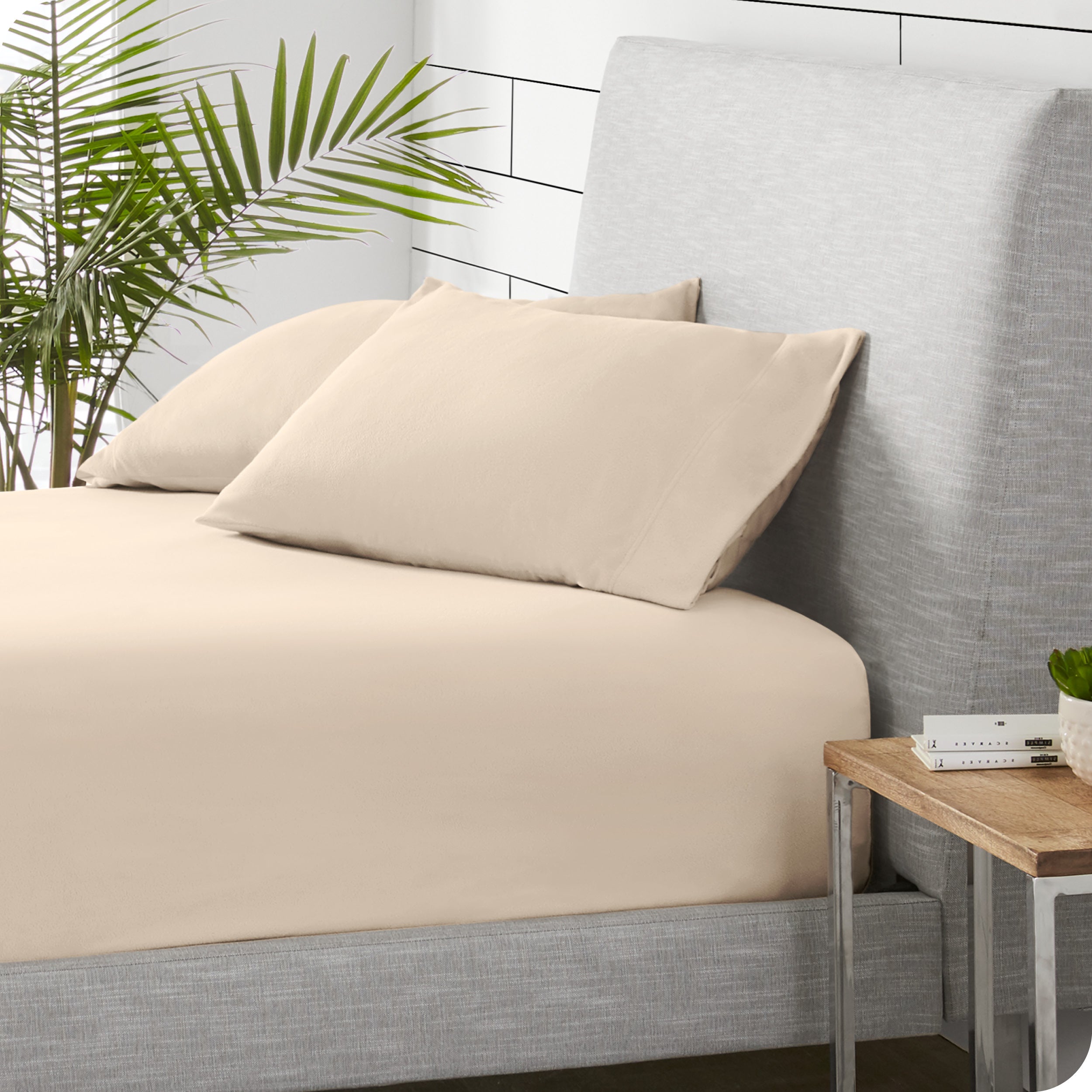 A sideview of a modern bed with a polar fleece fitted sheet on.