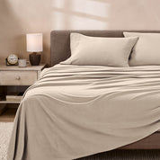 View of fleece sheets from the end of a bed with the top sheet draped over the side and end