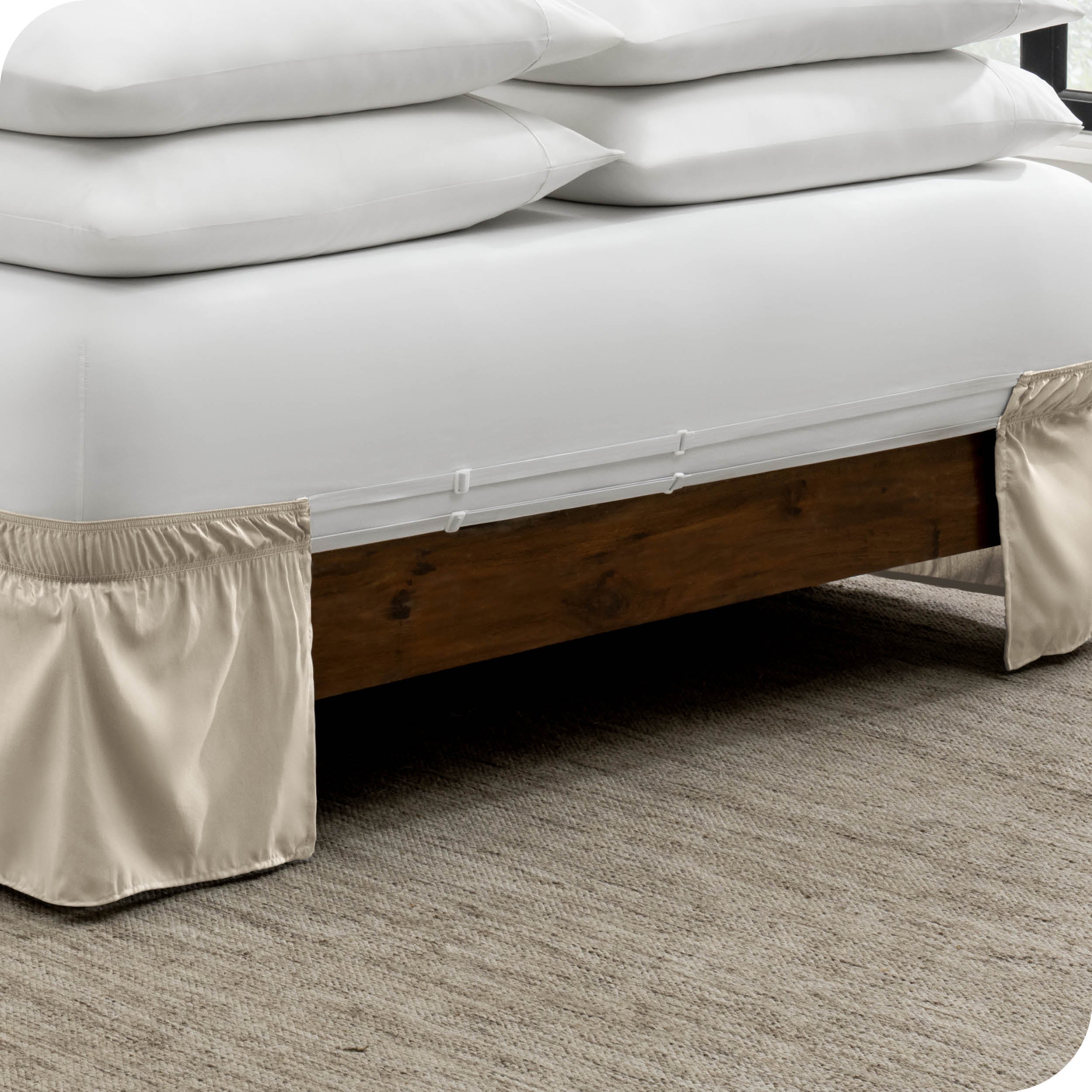 The adjustable elastic belt of a bed skirt wrapped around the mattress