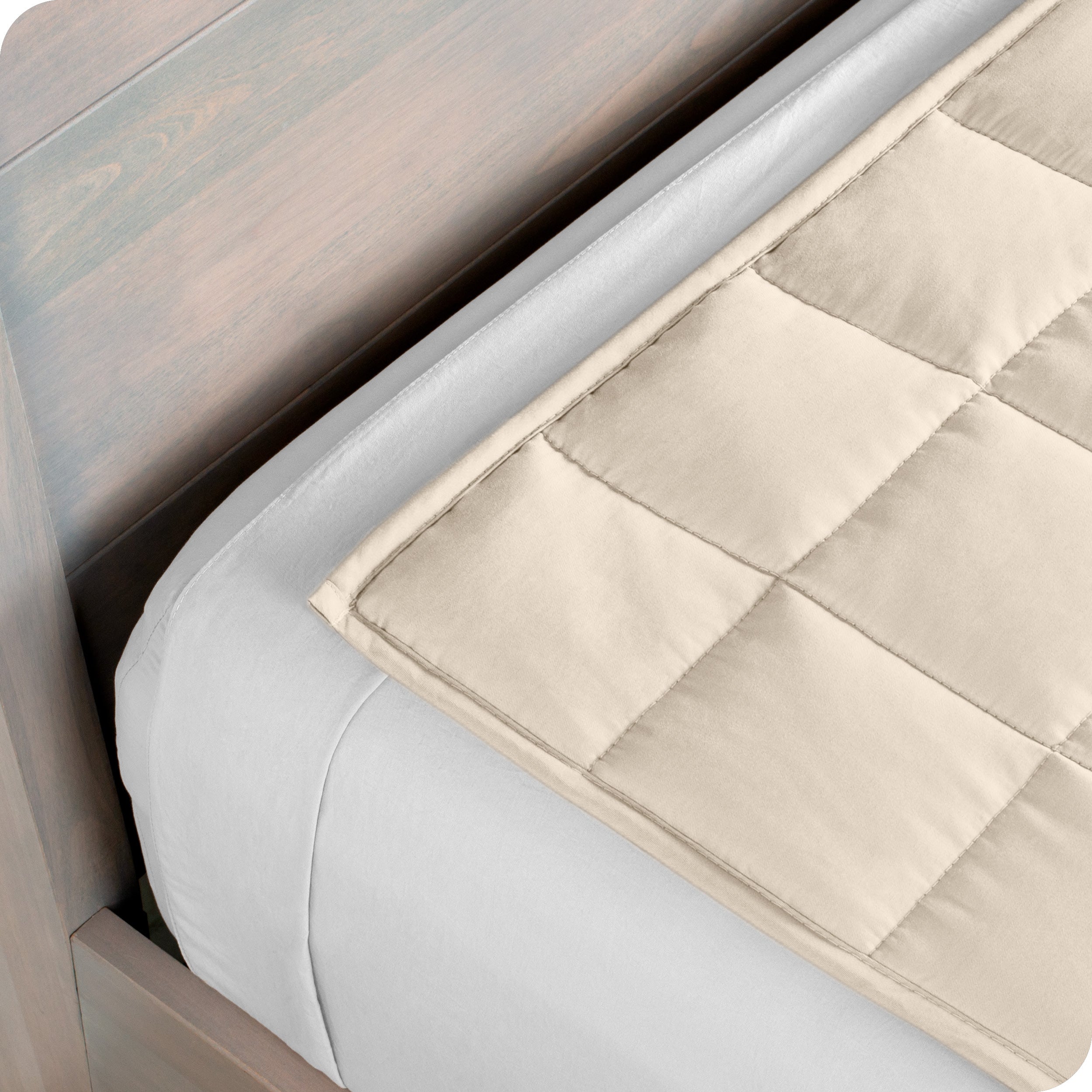 Close up of the corner of a weighted blanket on a bed