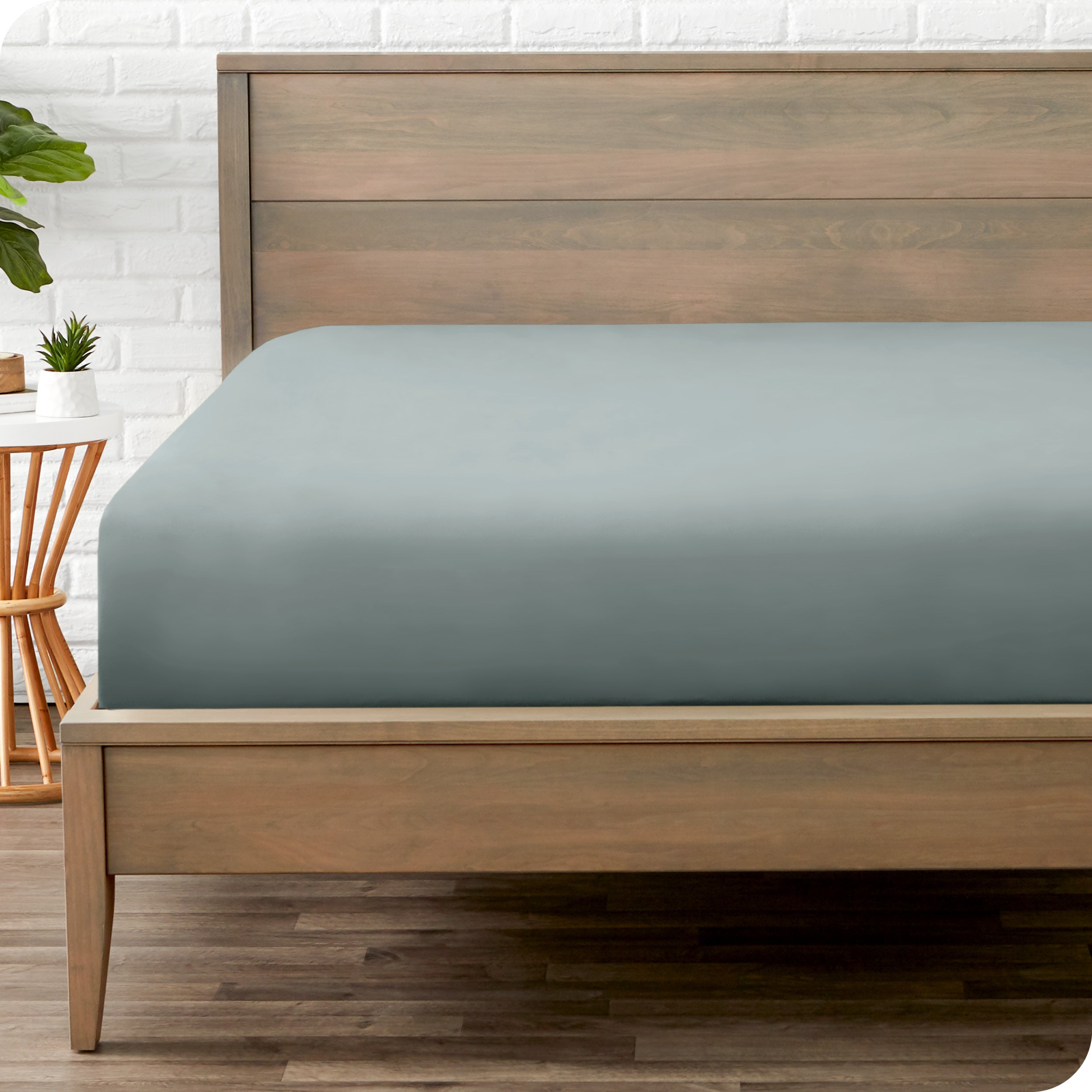 End of bed view with fitted sheet made on the mattress of a modern bed. 