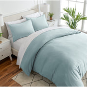 Angled view of bed with a duvet cover folded over on itself