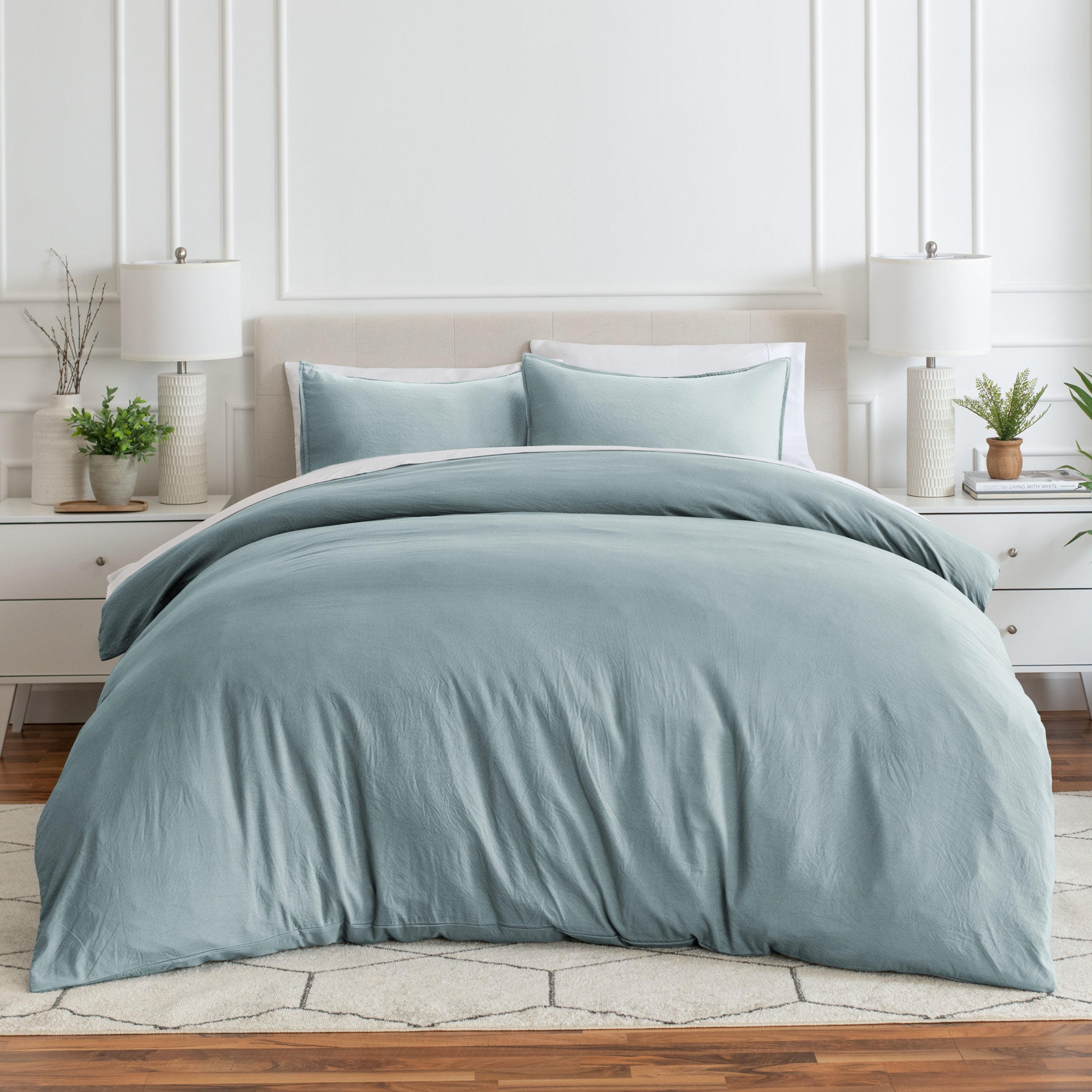 Relaxing room scene with a duvet cover laid out over the bed