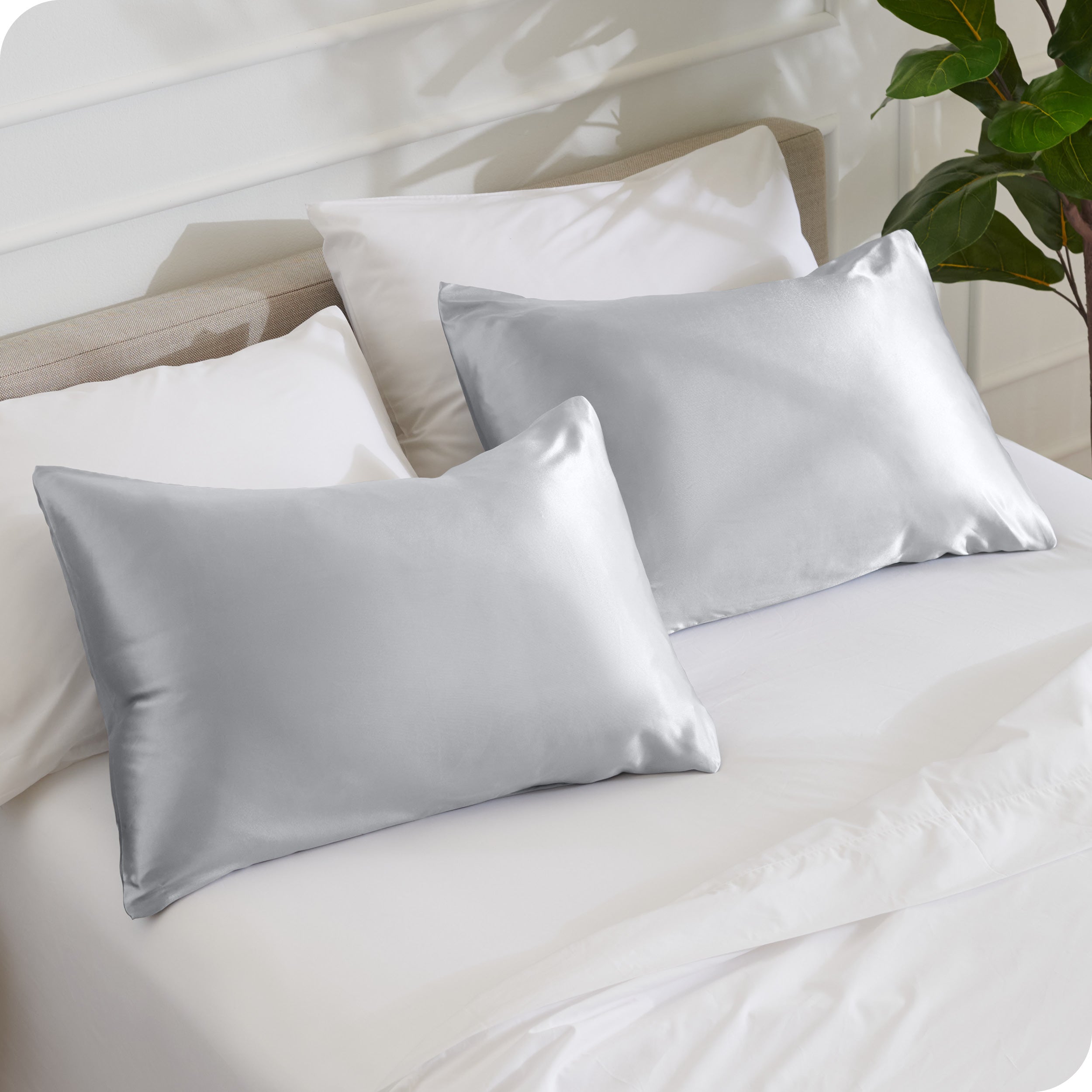 2 pillows with silk pillowcases on a bed
