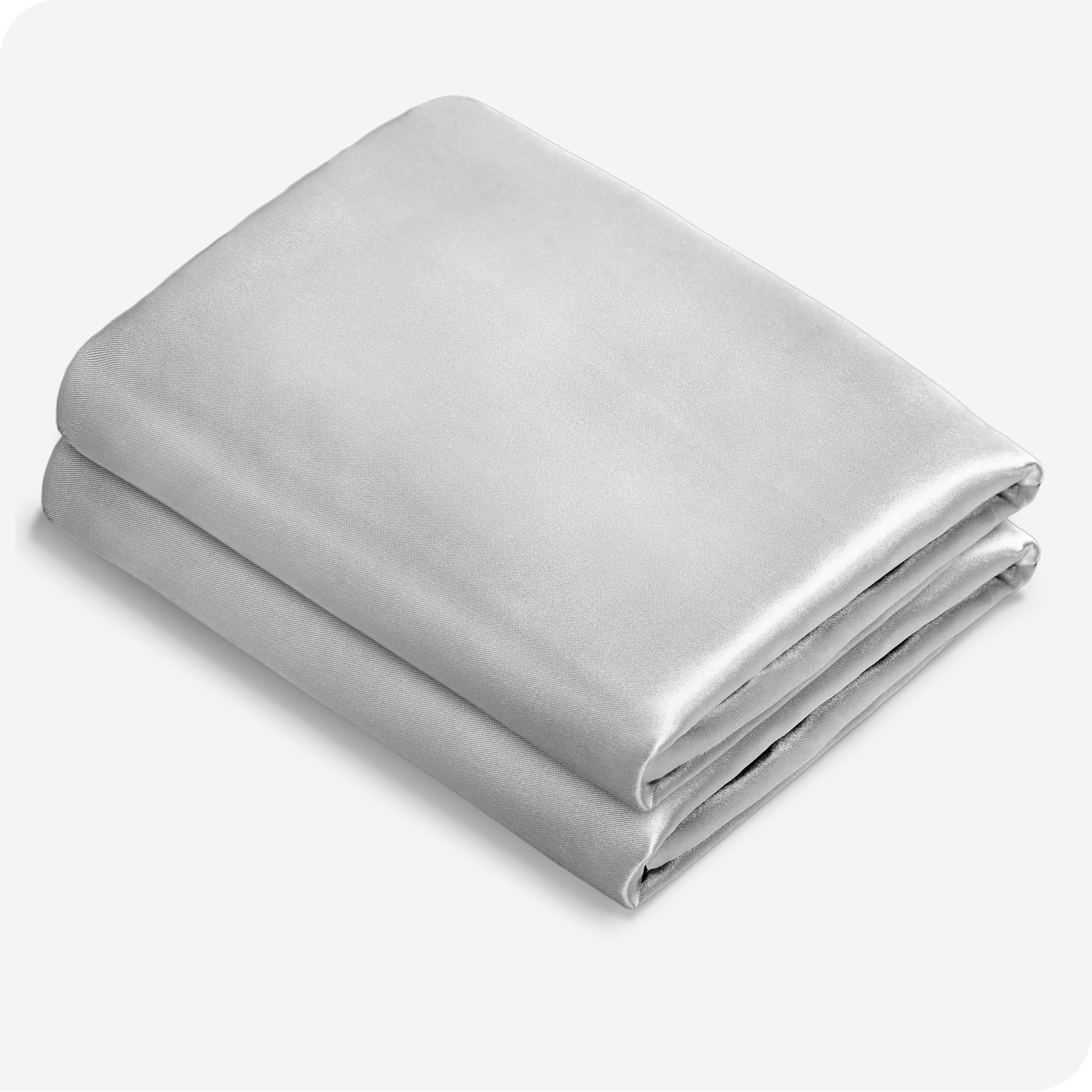 Two silk pillowcases folded and stacked neatly
