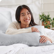 A woman resting her arm on a pillow