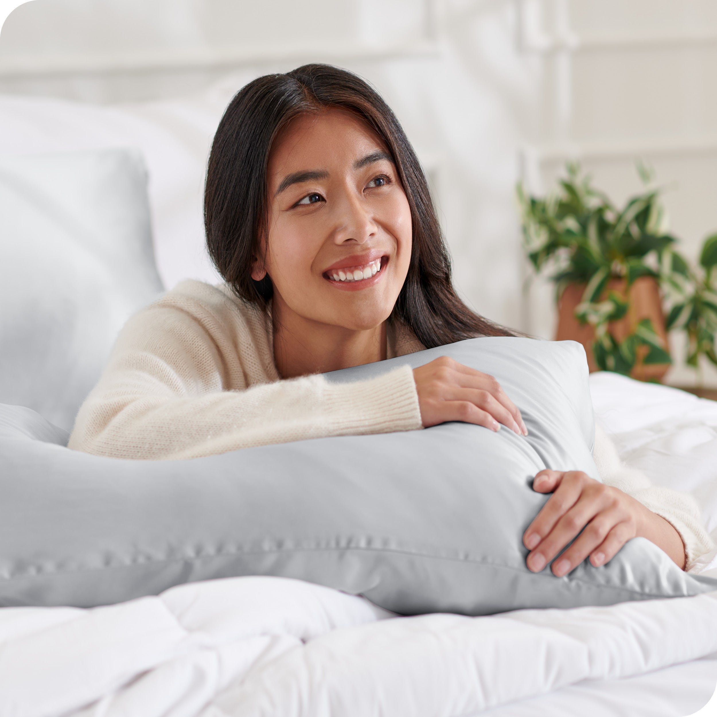 A woman resting her arm on a pillow