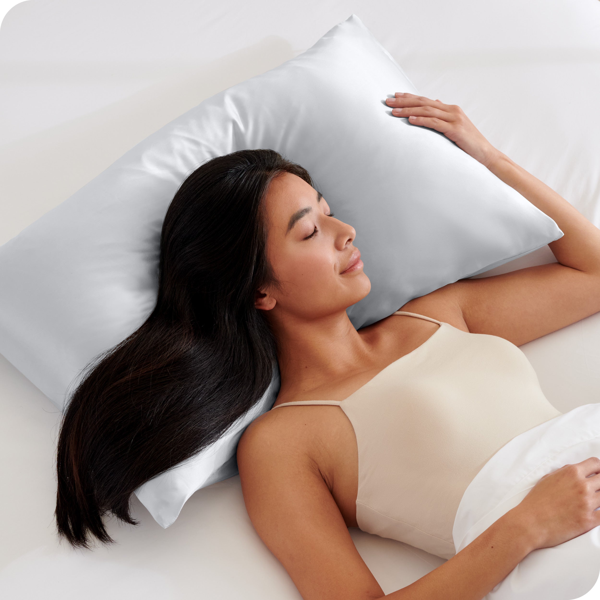A woman sleeping on a silk pillowcase