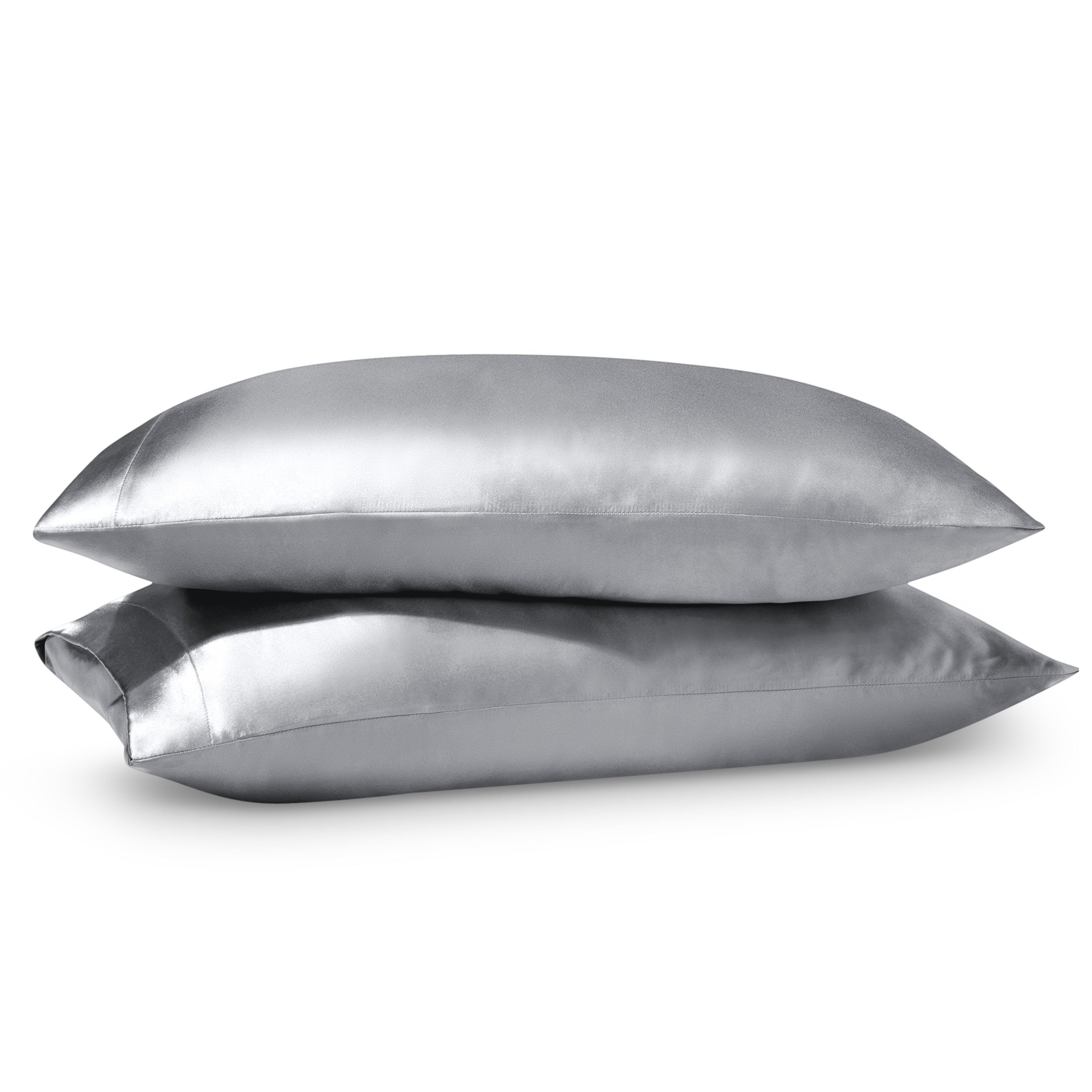 Two pillows on a white background with satin pillowcases on them.
