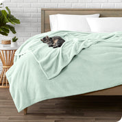 Microplush blanket laid out over a bed and folded back over itself