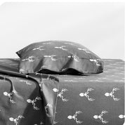 A flannel pillowcase on a pillow set on a bed with matching sheets