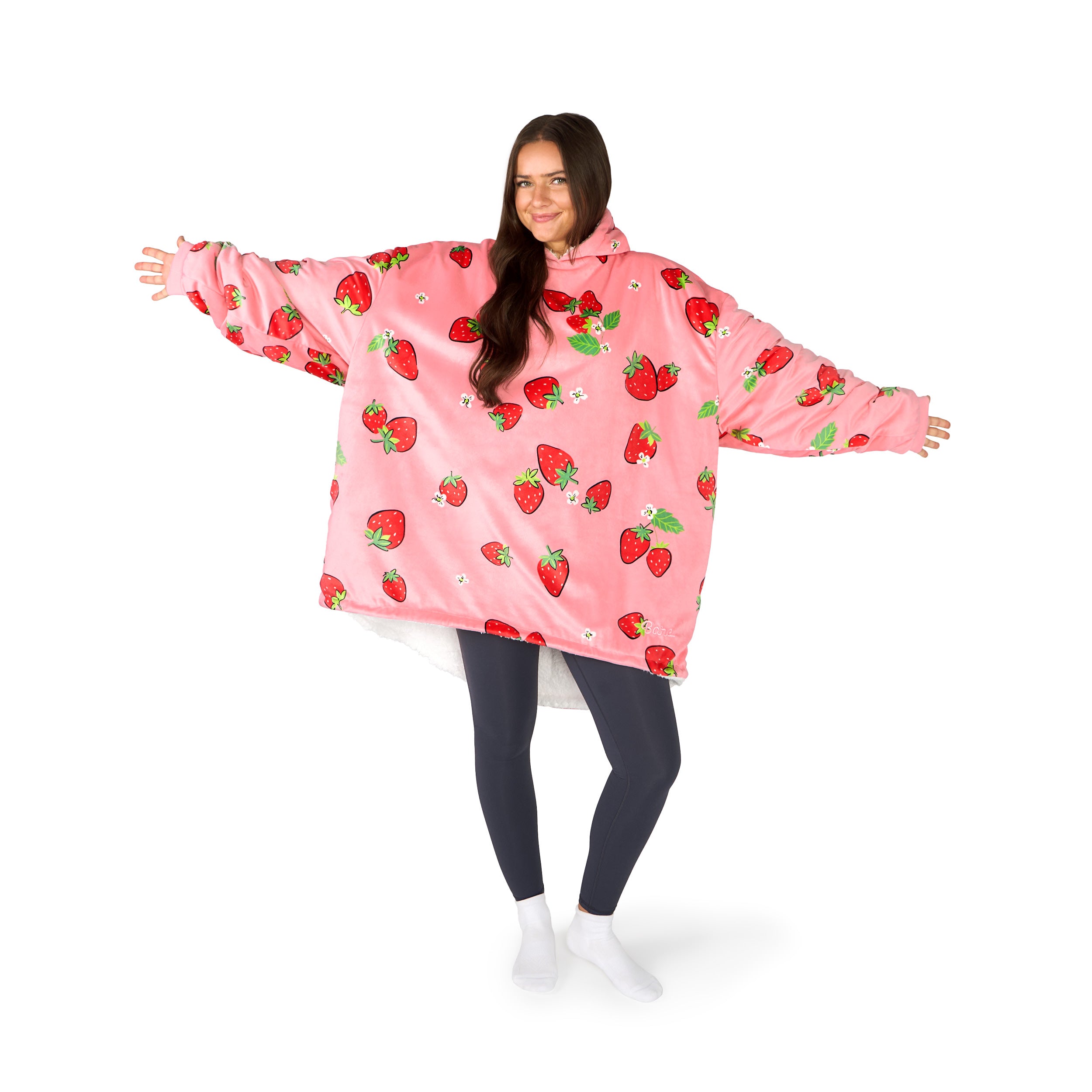 An adult with a hooded wearable blanket on