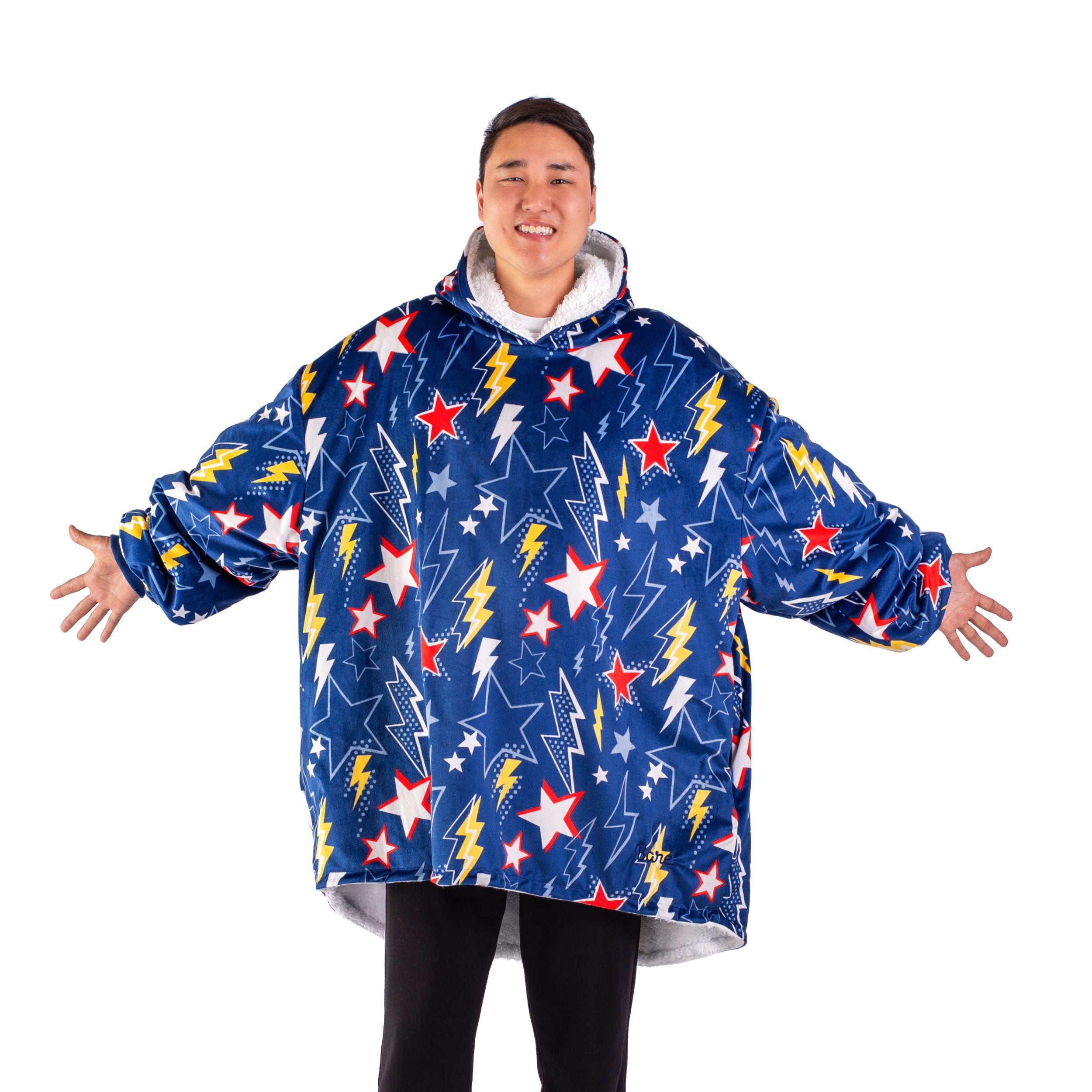 An adult with a hooded wearable blanket on