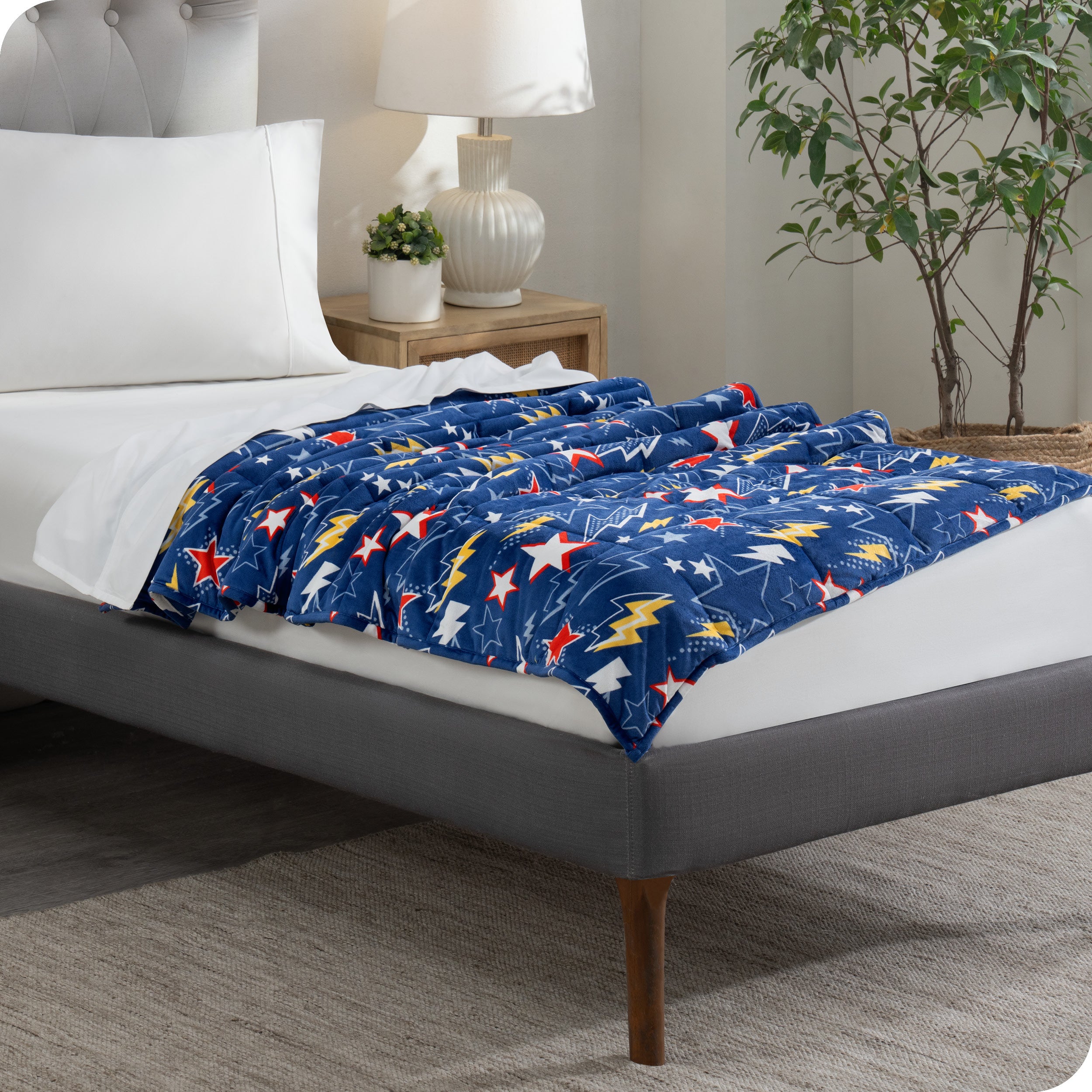 A weighted blanket laid out on a bed