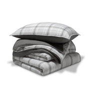 A comforter folded with a matching pillow sham stacked on top