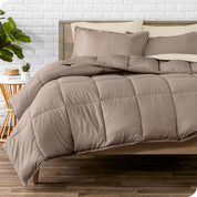 A wooden bed frame with sheets, pillow shams and a comforter on the bed