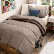 A college dorm room with a bed in a bag set on the mattress