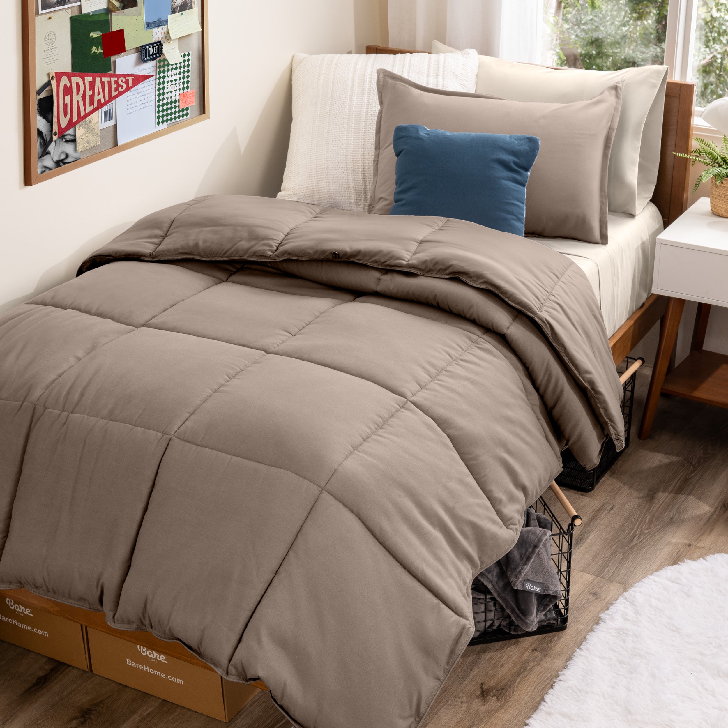 A college dorm room with a bed in a bag set on the mattress