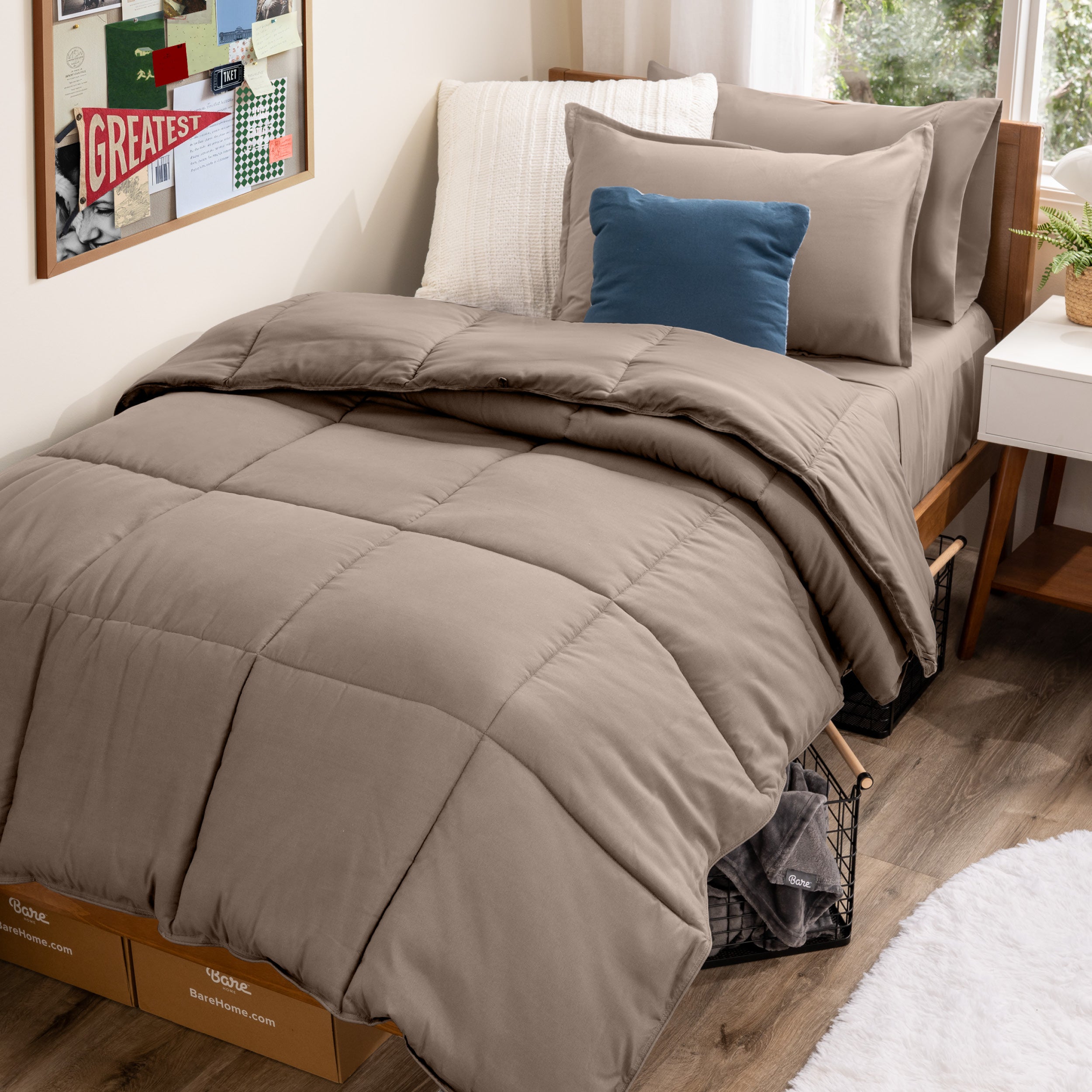 A college dorm room with a bed in a bag set on the mattress