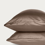 Two bamboo pillowcases on a light gray background