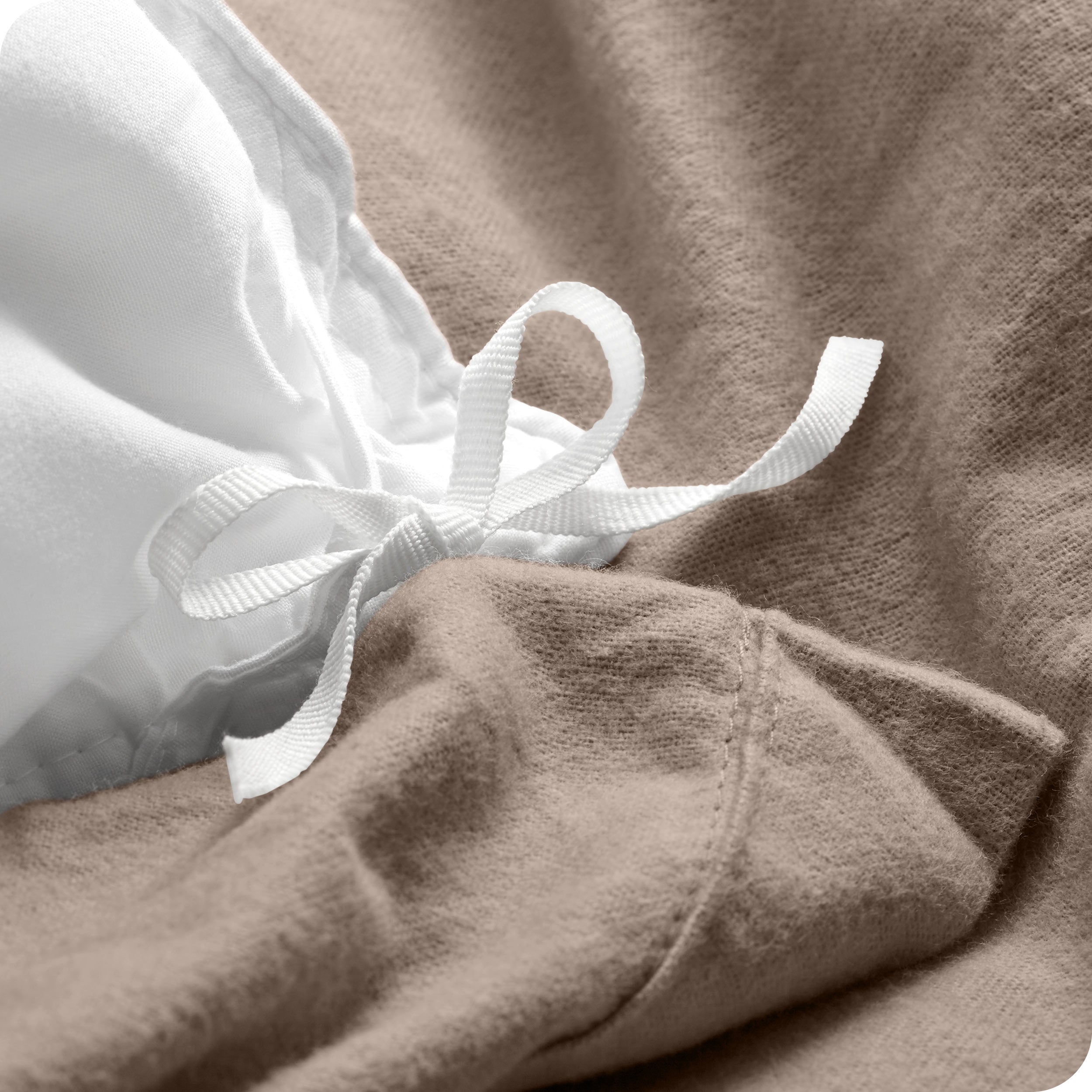 A folded stack of a flannel duvet cover with two pillows on top.