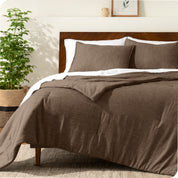 A modern bed with a down alternative comforter set on it
