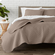A quilted coverlet set on a bed