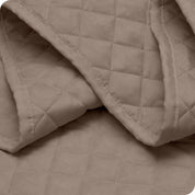 Close up of a coverlet showing the stitching